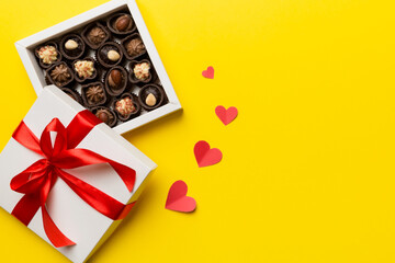 Delicious chocolate pralines in red box for Valentine's Day. Heart shaped box of chocolates top...