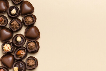 Different kinds of chocolates on colored table close-up. Top View and Flat Lay with copy space