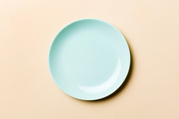Top view of isolated of colored background empty round blue plate for food. Empty dish with space for your design