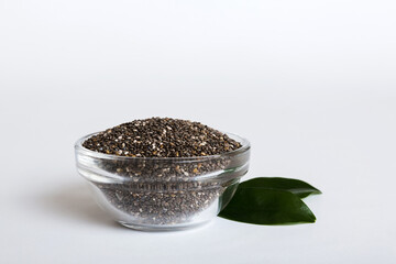Chia seeds in bowl on colored background. Healthy Salvia hispanica in small bowl. Healthy superfood