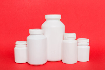 supplement pills with medicine bottle health care and medical top view. Vitamin tablets. Top view mockup bottle for pills and vitamins with green leaves, natural organic bio supplement, copy space