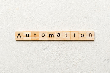 Automation word written on wood block. Automation text on cement table for your desing, concept