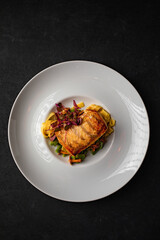 Delicious spanish food, dishes on a dark background in a restaurant, tasty looking dishes