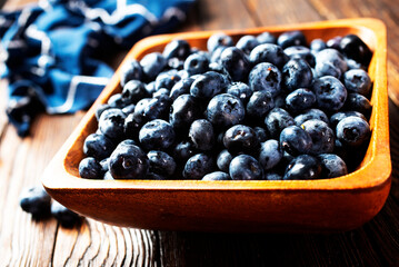 Freshly picked blueberries in wooden bowl. Juicy and fresh blueberries