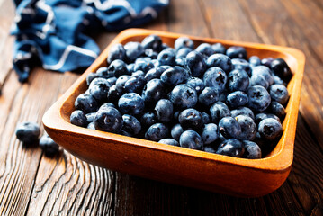 Freshly picked blueberries in wooden bowl. Juicy and fresh blueberries
