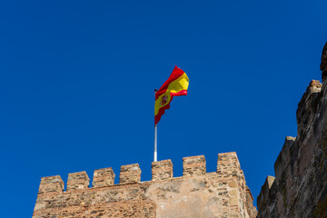 Spanish flag over Sohail Castle in Fuengirola, Spain on September 17, 2022