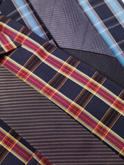 Closeup of two tartan shirts with ties