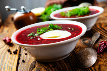 Traditional Ukrainian Russian borscht . Bowl of red beet root soup borsch with white cream . Beet Root delicious soup . Traditional Ukrainian food cuisine - 558489212