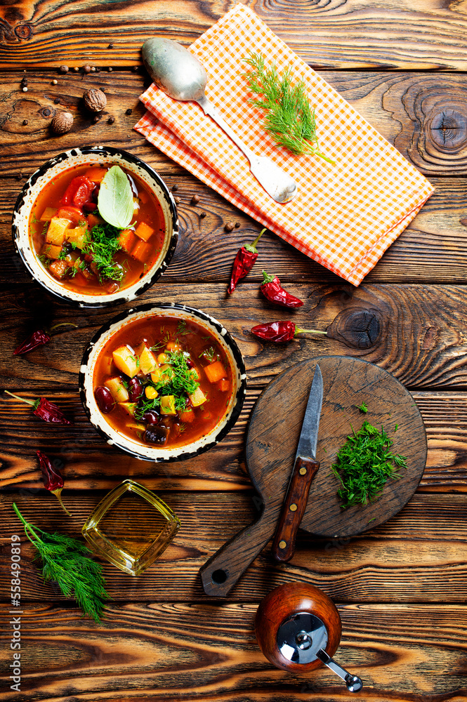 Wall mural chili soup in bowl with corn and been on dark background. mexican cuisine. top view