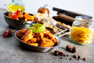 Thai beef stir-fry with pepper and basil on plate on a stone background with copy space. Top view, flat lay