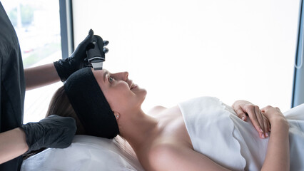 Woman on ultrasonic cleaning procedure. Hardware cosmetology. 