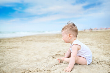 Happy little toddler boy portrait Playing With Sand in the beach