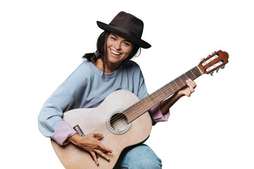 Young beautiful cheerful hispanic woman smiles widely and playing guitar, dressed in a light sweater and a brown hat with a brim on transparent background, saw something funny and laughed.