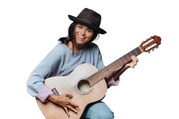 Young beautiful cheerful hispanic woman smiles widely and playing guitar, dressed in a light sweater and a brown hat with a brim on transparent background, saw something funny and laughed.