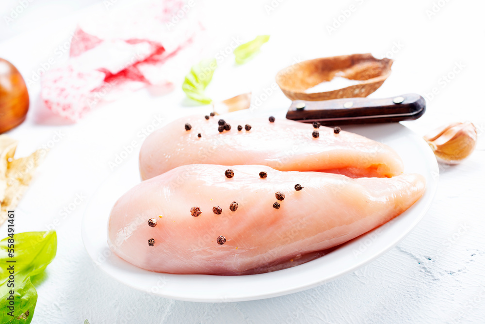 Sticker Raw sliced chicken breast fillet steaks on white plate