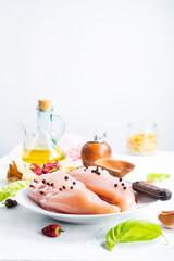 Raw sliced chicken breast fillet steaks on white plate