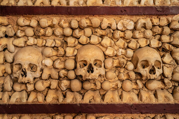 Human skull bone chapel in Portugal with skulls in the wall - obrazy, fototapety, plakaty