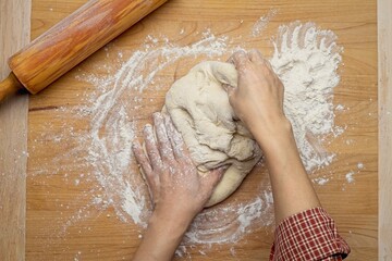 Kneading dough on a cutting board.
