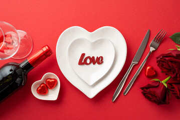 Valentine's Day concept. Top view photo of heart shaped dishes with inscription love knife fork wine bottle wineglass with confetti bouquet of roses and chocolate candies on isolated red background