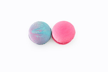 Sweet colorful macarons isolated on white background. Tasty colourful macaroons. Two multi-colored blue and pink macaroons. French pastry made from egg whites.