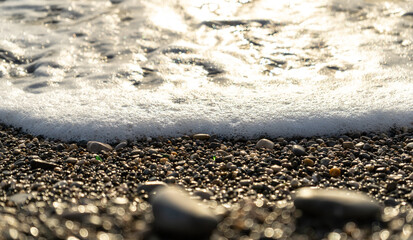 Sea Waves on Pebble Beach Texture Background