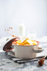porridge with butter in plate on rustic table