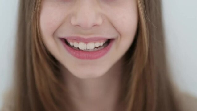 Slow motion video with a smiling little girl with a long hair