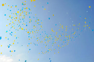 blue and yellow balloons in the blue sky