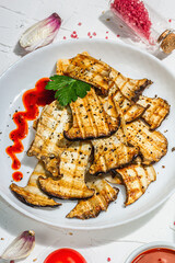 Fried slices Pleurotus eryngii mushrooms with sauce, spices and herbs. Healthy vegan food concept