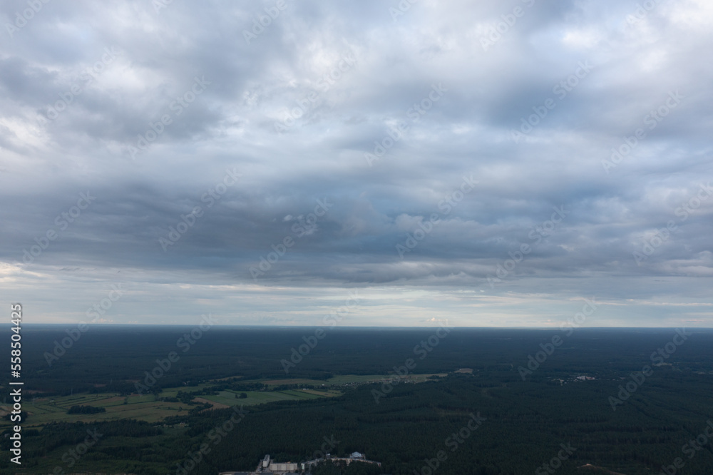 Aufkleber an aerial view of a large field with a sky filled with clouds above it and a large building in the m