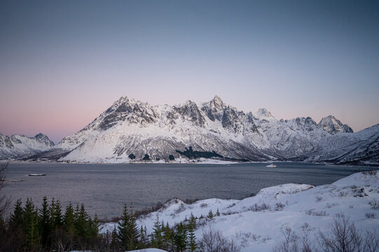 Reine, Lofoten islands, Norway. Nothen light, mountains and frozen ocean. Winter landscape at the night time. Norway travel - image. 
