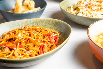 Various dishes of Asian food. Pork noodles, spring rolls. Selective focus. High quality photo