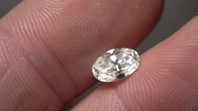 2 Carat Loose Oval Diamond in Palm of the Hand - Macro Close Up