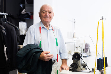 Portrait of an accomplished elderly tailor at his workplace in a sewing workshop