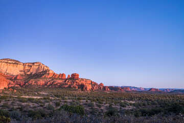 At sunset, Bear Mountain can be seen in the distance from the Red Rock-Secret Mountain Wilderness, which is located in Yavapai County, Arizona and is part of the Coconino National Forest. 