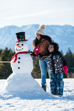 Two girls building a snowman in Stateline, Nevada.