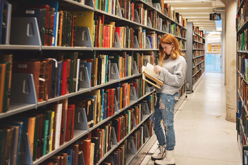 Teen girl looking through books at the library.