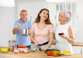 Happy family of three preparing lunch together in a modern kitchen