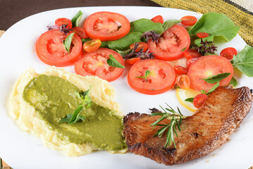 Fototapeta na wymiar healthy meal mashed potato salad fried fish tomato and basil pesto
