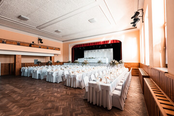 Beautiful wedding room with wedding table with food, flowers and drinks, decorations,lights everywhere