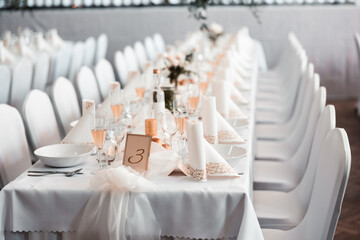 Beautiful wedding room with wedding table with food, flowers and drinks, decorations,lights everywhere
