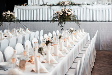 Beautiful wedding room with wedding table with food, flowers and drinks, decorations,lights everywhere