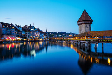 Historic city center of Lucerne with famous Chapel Bridge with blue sky and clouds at twilight, Canton of Lucerne, Switzerland