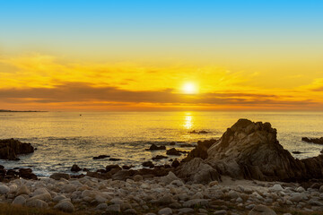 Fototapeta na wymiar A golden sunset from the coast of Monterey Bay in California