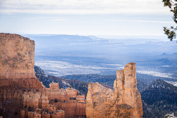 Fototapeta na wymiar Bryce Canyon accented in freshly fallen snow and distant mountains