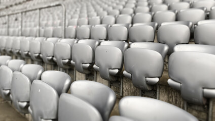 Gray empty chairs inside a soccer stadium