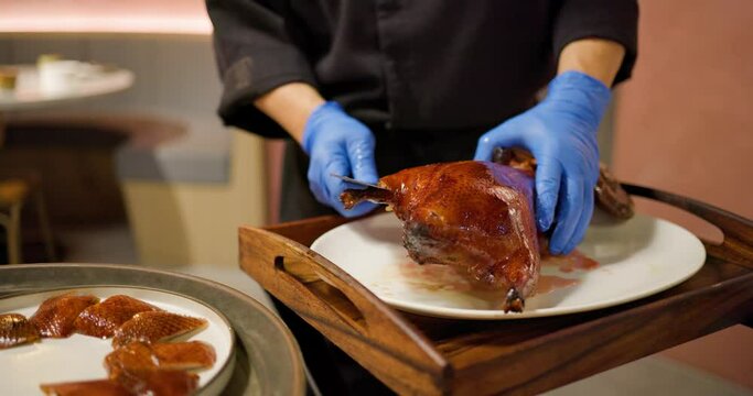 Chef cutting of Peking duck in restaurant