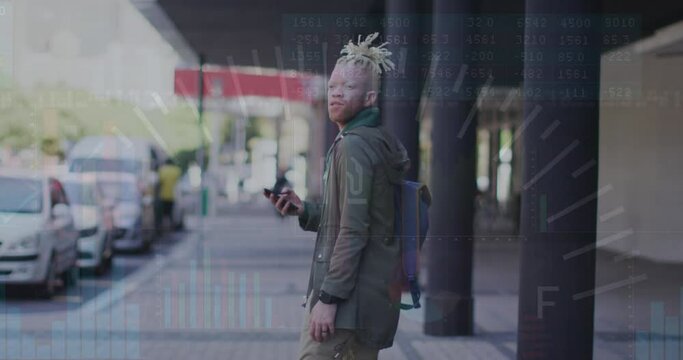 Animation of graphs, numbers on african american man with cellphone looking back and walking in city