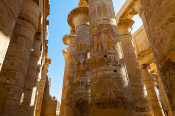 The Great Hypostyle Hall at the ancient Karnak Temple with giant painted sandstone columns in the...