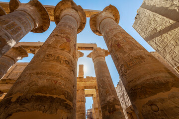 The Great Hypostyle Hall at the ancient Karnak Temple with giant painted sandstone columns in the...